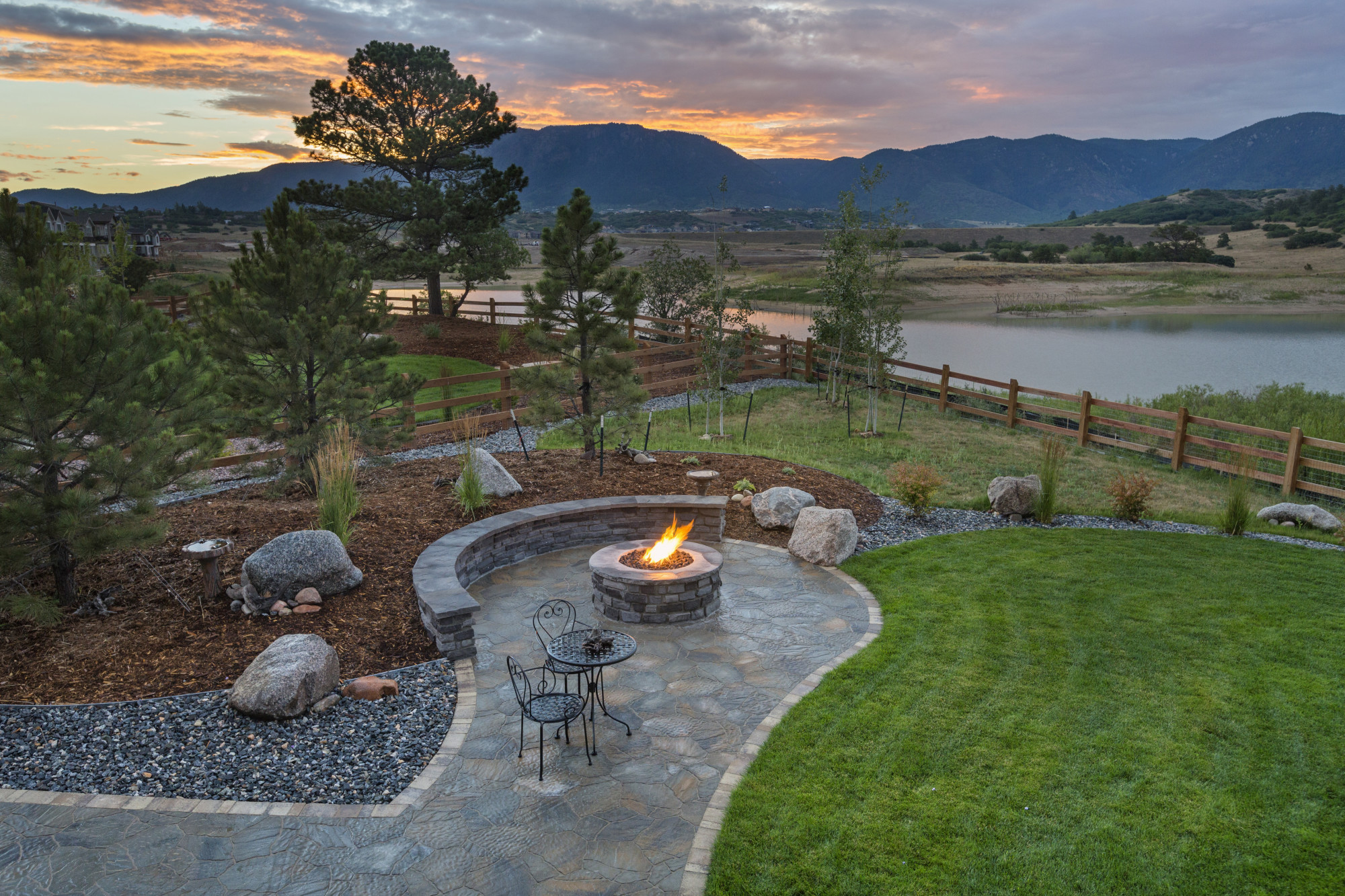 home landscape with fire pit and seating area