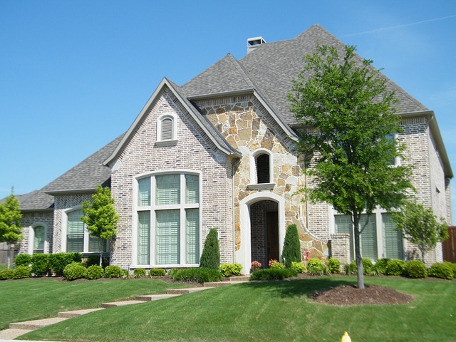 brick and stone house with gray roof